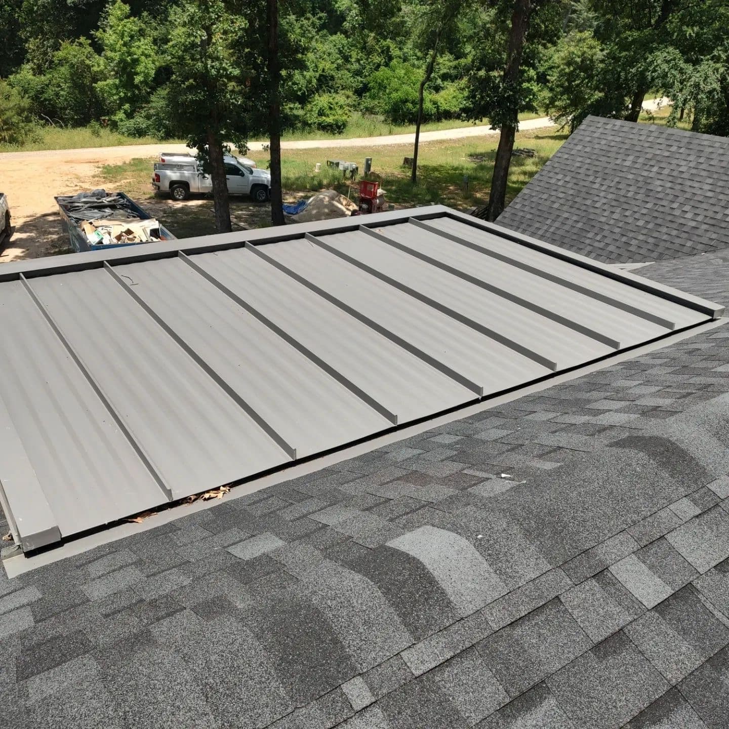 Detailed view of metal and architectural shingle roofing