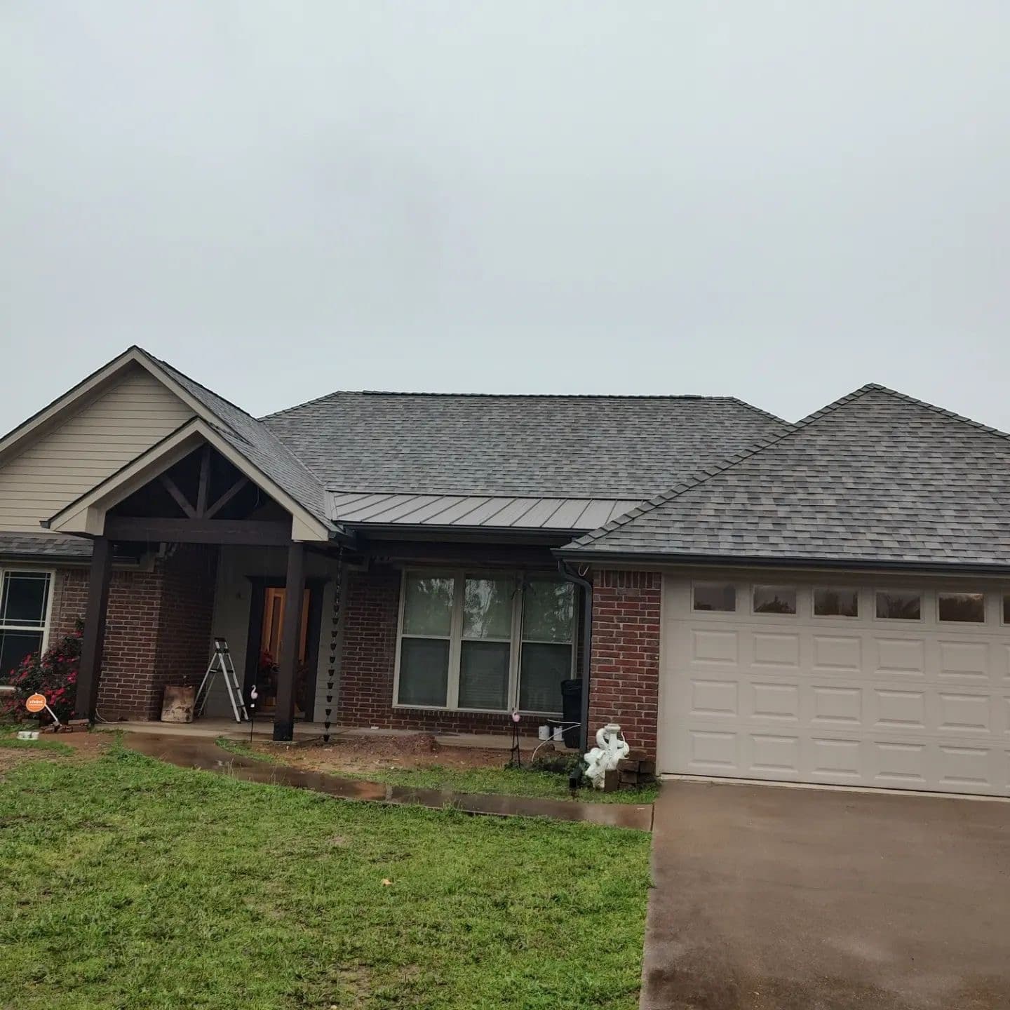 Residence with gray shingles and a metal accent roof on the porch