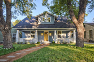 1920s bungalow in the spring with an asphalt shingle roof